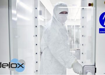 a person wearing protective clothing enters the clean room